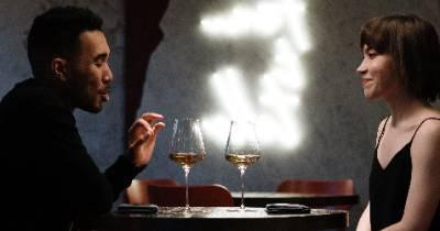 A woman and man sitting at a table talking